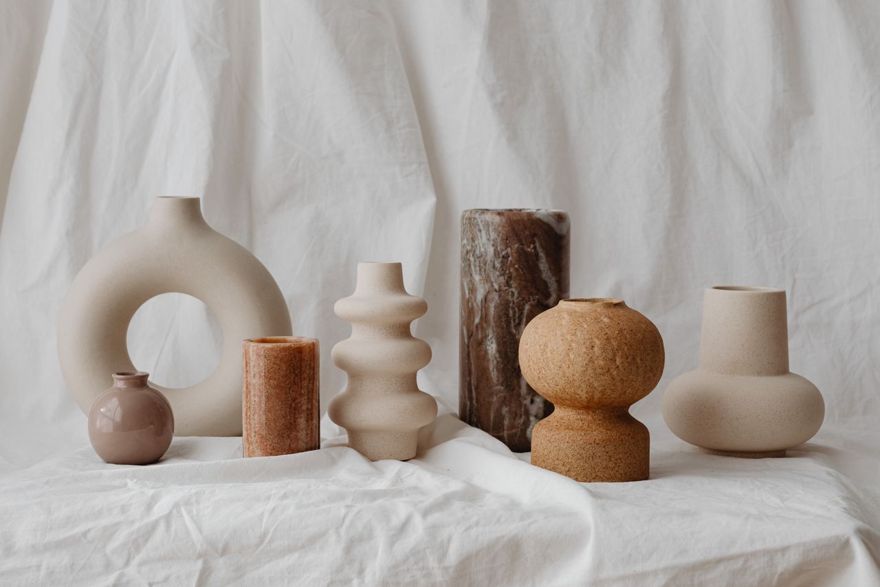 A curated assortment of unique ceramic vases in neutral tones, showcasing modern rustic design.